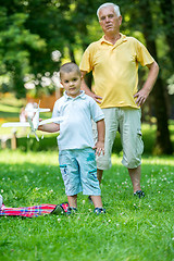 Image showing grandfather and child have fun  in park