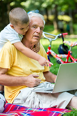 Image showing grandfather and child using laptop