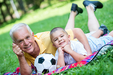 Image showing grandfather and child have fun  in park