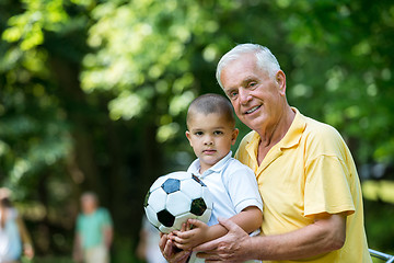 Image showing grandfather and child have fun  in park