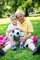 Image showing grandfather and child have fun  in park