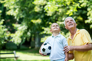 Image showing grandfather and child have fun  in park