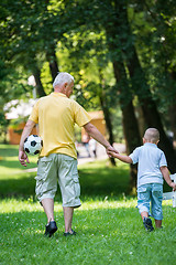 Image showing grandfather and child have fun  in park