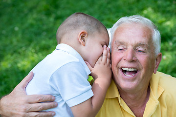 Image showing grandfather and child have fun  in park