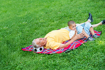 Image showing grandfather and child have fun  in park