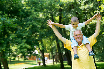 Image showing grandfather and child have fun  in park