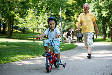 Image showing grandfather and child have fun  in park