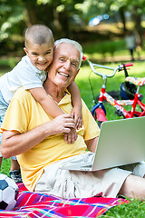 Image showing grandfather and child using laptop