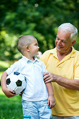 Image showing grandfather and child have fun  in park