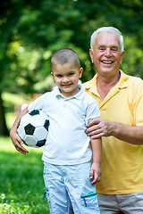 Image showing grandfather and child have fun  in park