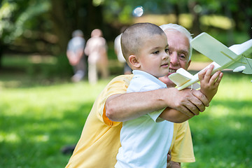 Image showing grandfather and child have fun  in park