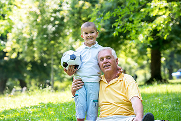 Image showing grandfather and child have fun  in park