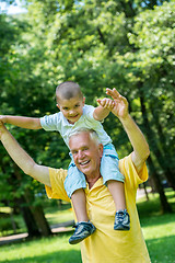 Image showing grandfather and child have fun  in park