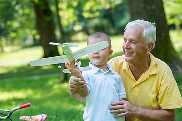 Image showing grandfather and child have fun  in park