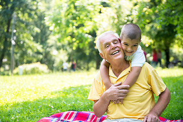 Image showing grandfather and child have fun  in park