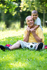 Image showing grandfather and child have fun  in park