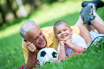 Image showing grandfather and child have fun  in park