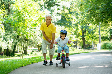 Image showing grandfather and child have fun  in park