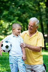 Image showing grandfather and child have fun  in park