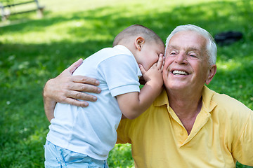 Image showing grandfather and child have fun  in park