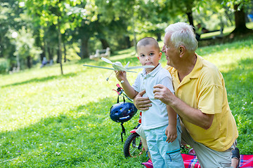 Image showing grandfather and child have fun  in park