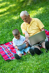 Image showing grandfather and child using laptop