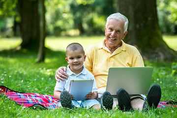 Image showing grandfather and child using laptop