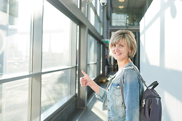 Image showing Woman with backpack going on boarding