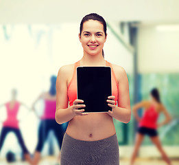 Image showing sporty woman with tablet pc blank screen