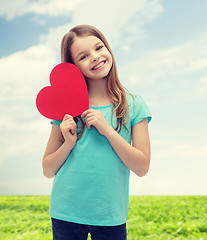 Image showing smiling little girl with red heart