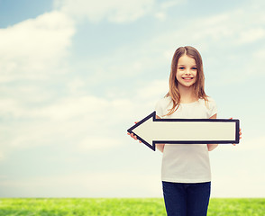 Image showing smiling girl with blank arrow pointing left