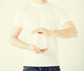 Image showing mans hands showing something