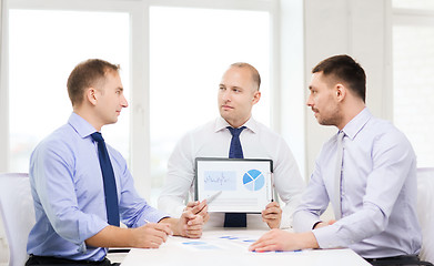 Image showing serious businessmen with papers in office