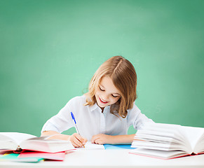 Image showing happy girl with books and notebook at school