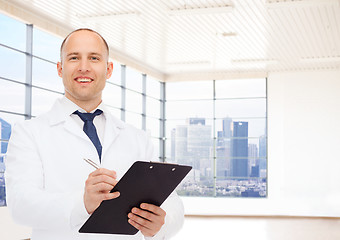 Image showing smiling male doctor with clipboard