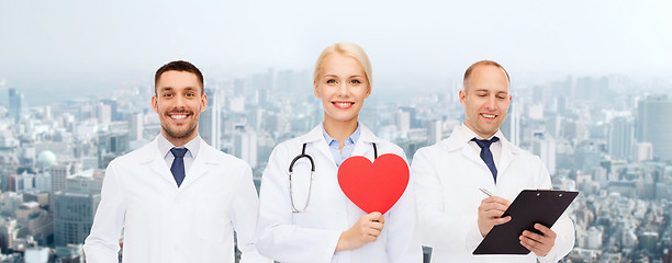 Image showing group of smiling doctors with red heart shape