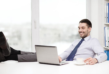 Image showing smiling businessman or student with laptop