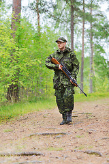 Image showing young soldier or hunter with gun in forest