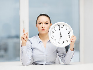 Image showing attractive businesswoman with white clock