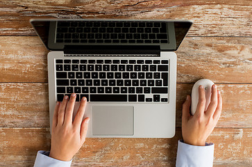 Image showing close up of female hands with laptop and mouse