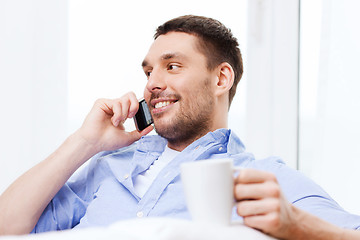 Image showing close up of smiling businessman with smartphone