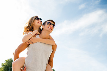 Image showing smiling couple having fun over sky background