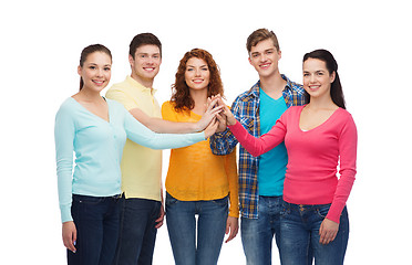 Image showing smiling teenagers making high five