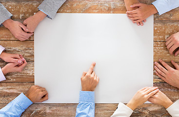 Image showing close up of business team with paper at table