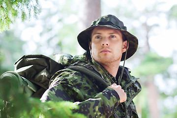 Image showing young soldier with backpack in forest