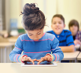 Image showing little school girl with tablet pc over classroom