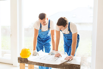 Image showing group of builders with blueprint