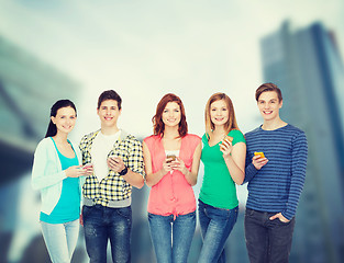 Image showing smiling students with smartphones