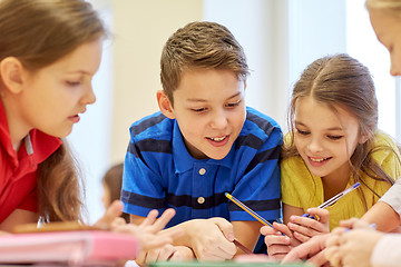 Image showing group of students talking and writing at school