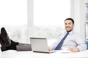 Image showing smiling businessman or student with laptop